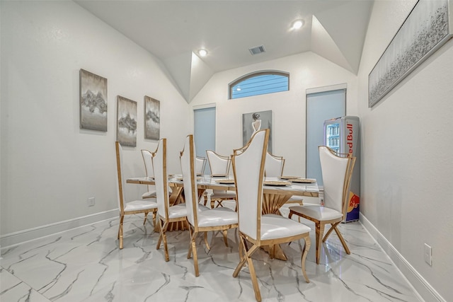 dining space featuring lofted ceiling