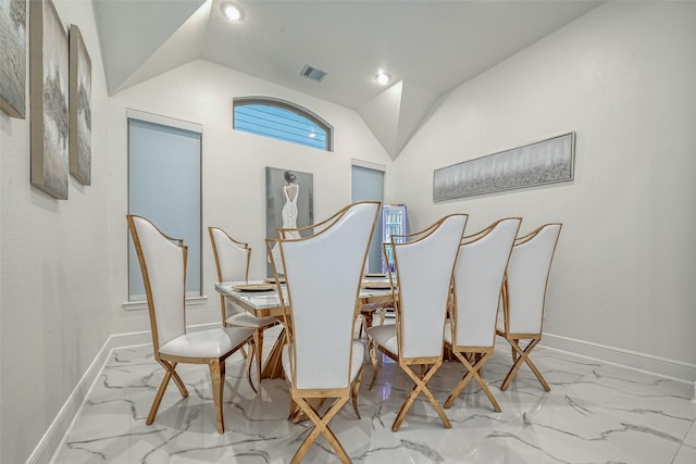 dining space featuring vaulted ceiling