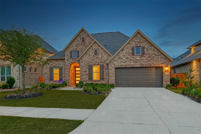 view of front facade with a front yard and a garage