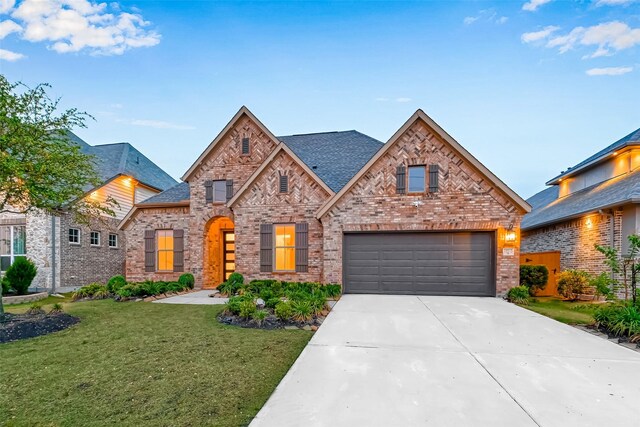 view of front facade with a garage and a front lawn