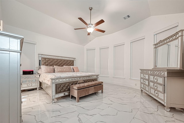 bedroom featuring vaulted ceiling, ceiling fan, and multiple closets