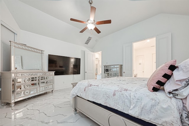 bedroom featuring ceiling fan, ensuite bathroom, and vaulted ceiling