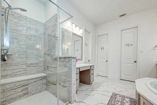 bathroom with a tile shower and vanity