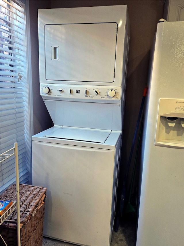 laundry area featuring stacked washing maching and dryer