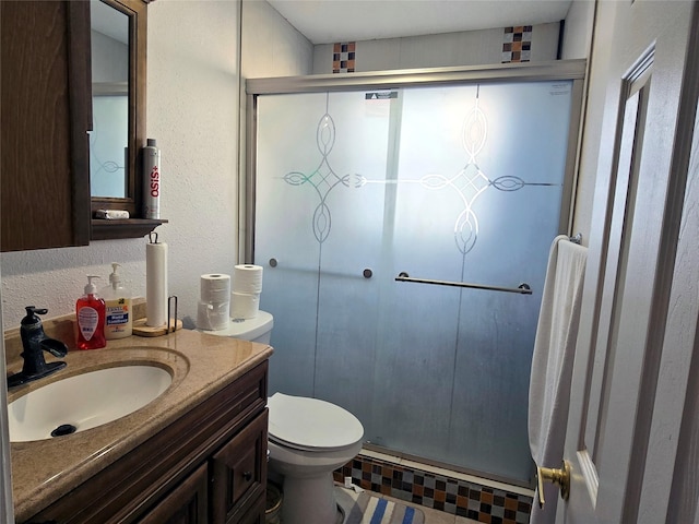 bathroom with vanity, toilet, and walk in shower