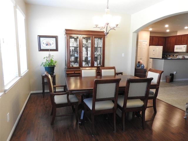 dining area featuring a chandelier and dark wood-type flooring