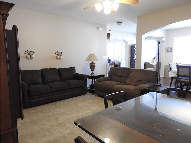 living room with plenty of natural light and ceiling fan