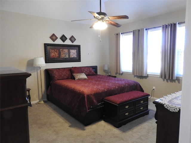 bedroom with light carpet and ceiling fan