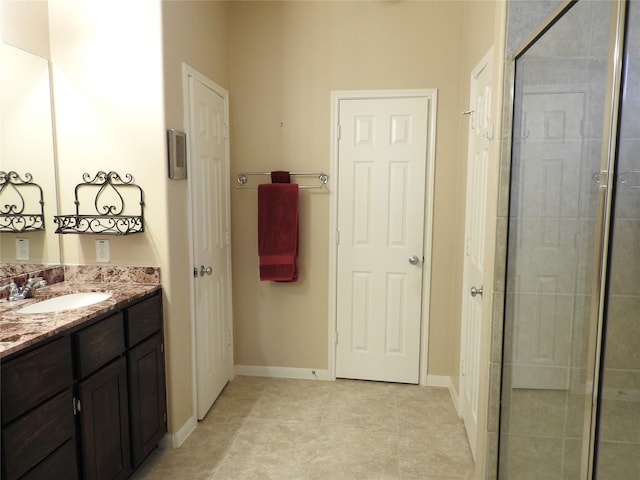 bathroom featuring tile patterned flooring, vanity, and an enclosed shower