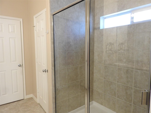 bathroom featuring tile patterned flooring and a shower with door