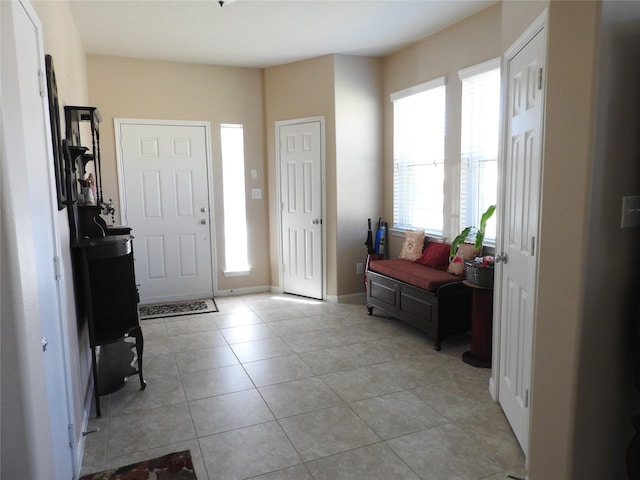 foyer entrance with light tile patterned floors