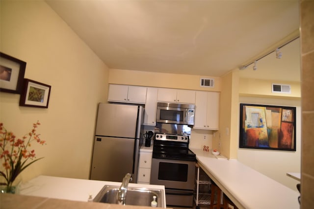 kitchen featuring sink, white cabinets, and stainless steel appliances