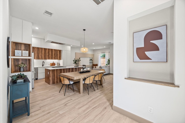 dining room with light wood-type flooring