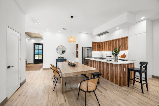 dining space with light hardwood / wood-style flooring