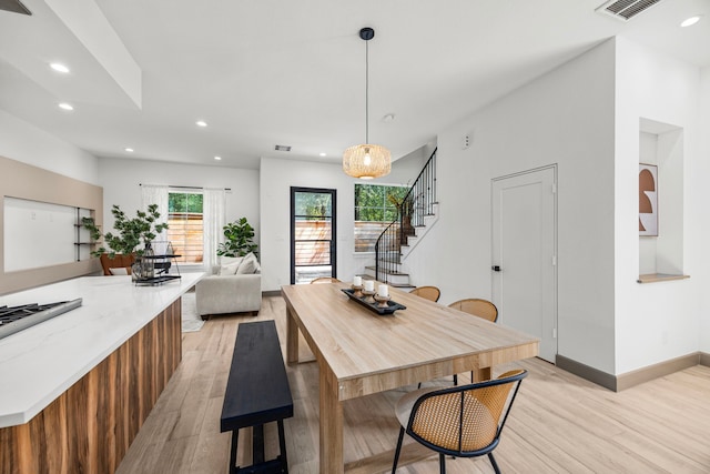 dining space with light hardwood / wood-style flooring