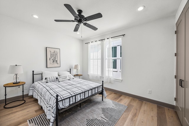 bedroom with ceiling fan and wood-type flooring