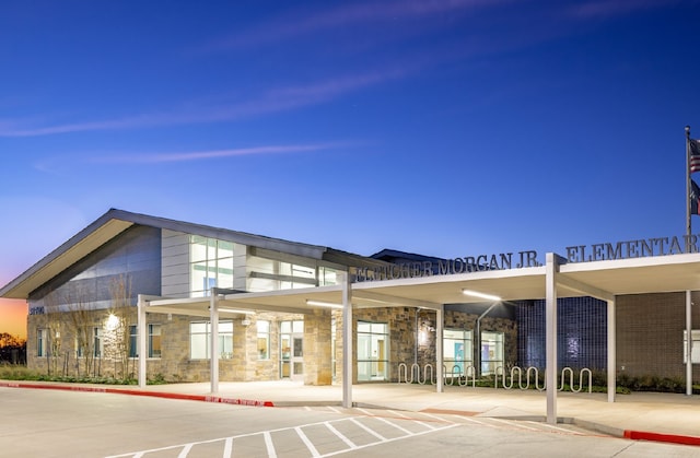 view of outdoor building at dusk