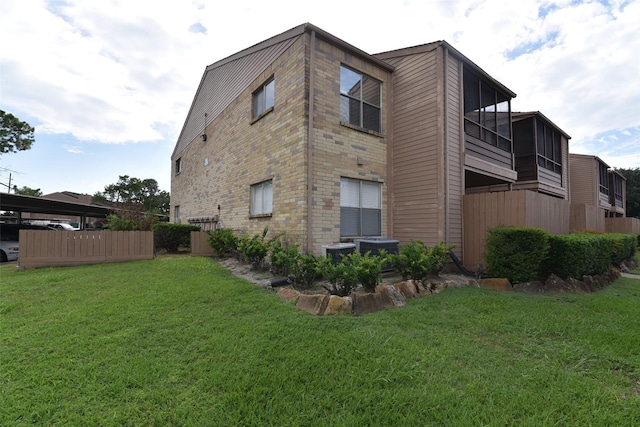 view of property exterior with a balcony and a lawn