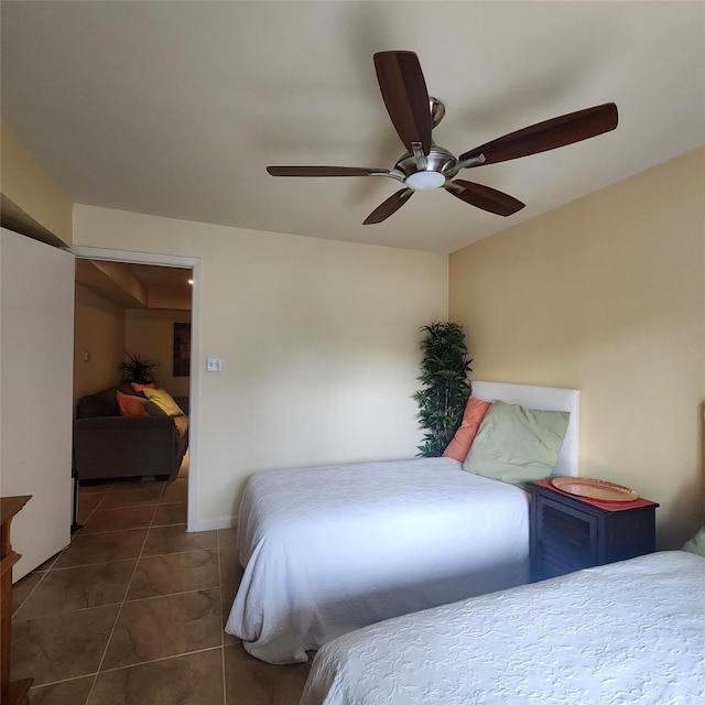 tiled bedroom with ceiling fan