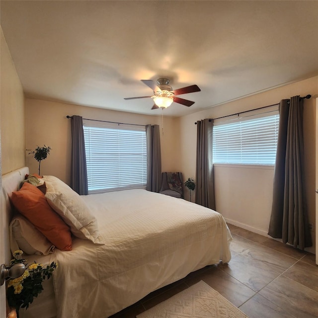 bedroom with tile patterned floors and ceiling fan