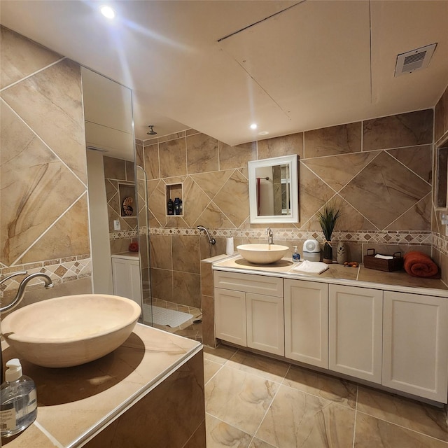 bathroom featuring a shower, decorative backsplash, vanity, and tile walls