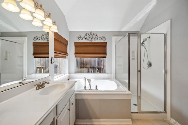 bathroom featuring tile patterned floors, vanity, separate shower and tub, and lofted ceiling