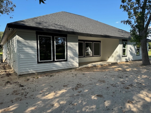 rear view of property featuring a patio area