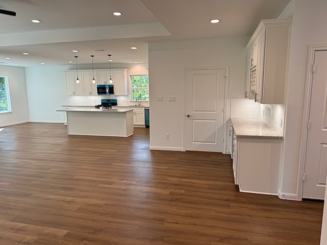 kitchen featuring white cabinetry, dark hardwood / wood-style flooring, decorative light fixtures, a kitchen island, and black appliances