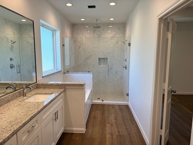 bathroom featuring vanity, hardwood / wood-style floors, and separate shower and tub