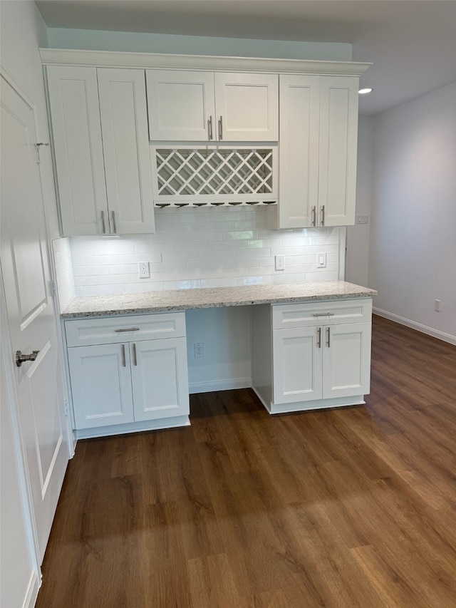 kitchen with white cabinets, dark hardwood / wood-style flooring, and tasteful backsplash