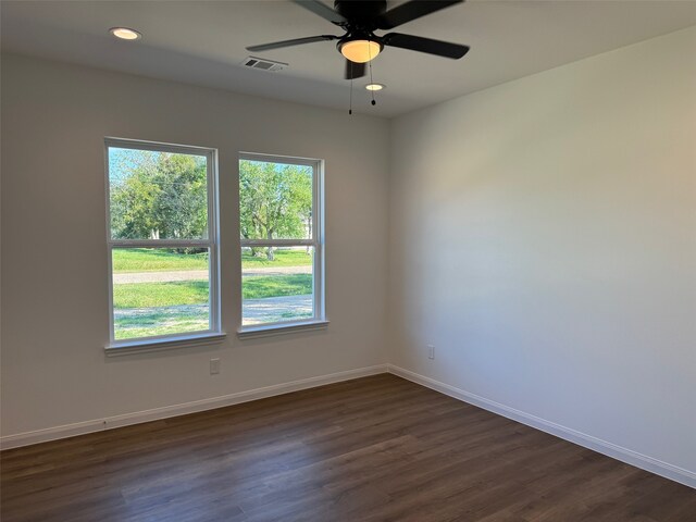 unfurnished room with ceiling fan and dark hardwood / wood-style flooring