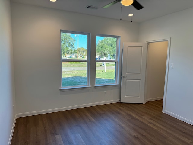 unfurnished room featuring dark wood-type flooring and ceiling fan