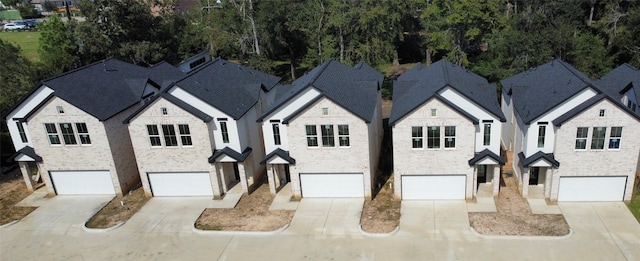 7934 Hennessy Ln Unit 6, Spring, TX 77389 - view of front facade featuring driveway, an attached garage, and a chimney