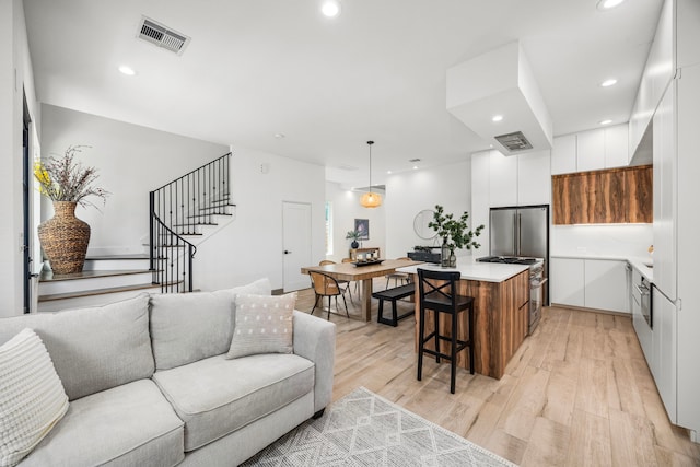7934 Hennessy Ln Unit 6, Spring, TX 77389 - living area with light wood-style floors, stairway, and recessed lighting
