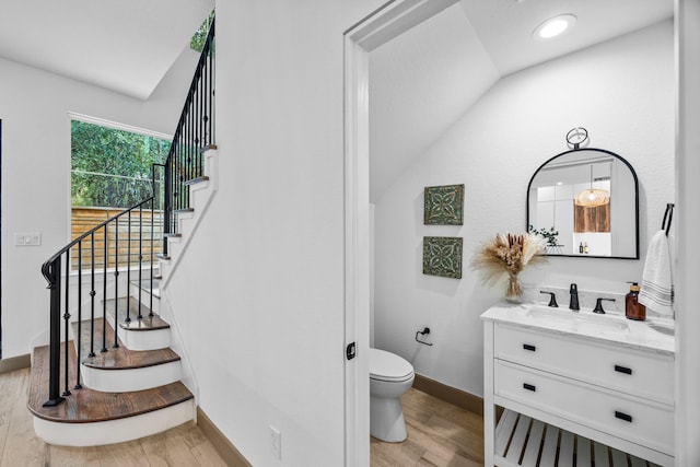 7934 Hennessy Ln Unit 6, Spring, TX 77389 - bathroom with vaulted ceiling, vanity, and wood finished floors