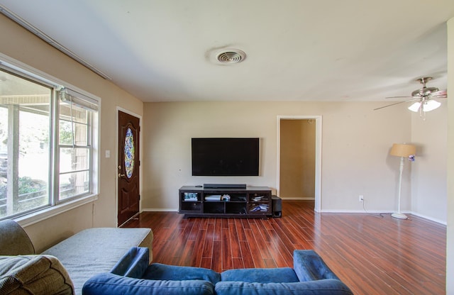 living room with dark hardwood / wood-style floors and ceiling fan