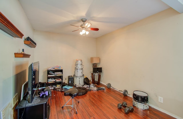 exercise room with ceiling fan and hardwood / wood-style floors