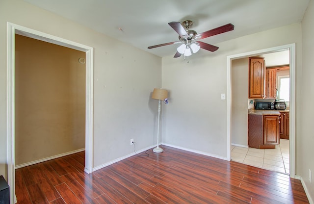 spare room with ceiling fan and dark wood-type flooring