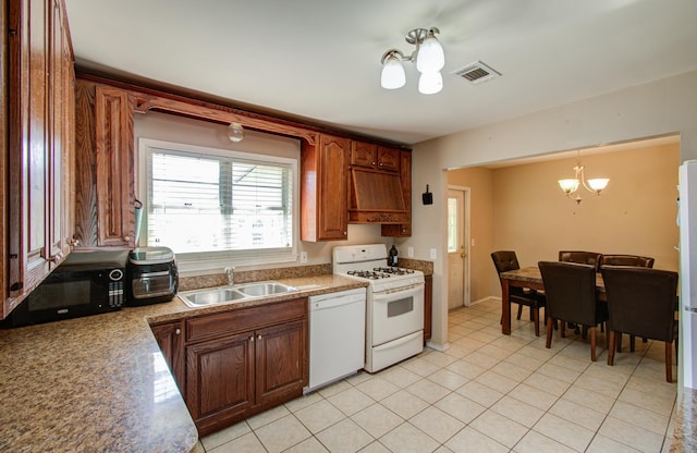 kitchen featuring custom exhaust hood, white appliances, sink, light tile patterned floors, and a notable chandelier