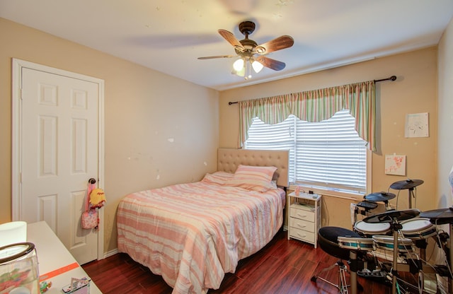 bedroom with dark hardwood / wood-style flooring and ceiling fan