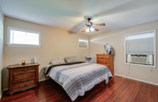 bedroom featuring dark hardwood / wood-style floors, ceiling fan, and cooling unit