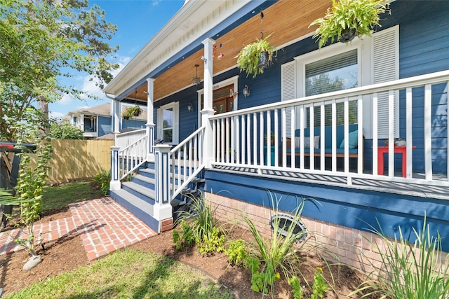 view of exterior entry with covered porch