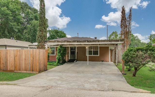 view of front of house with a front yard and a carport