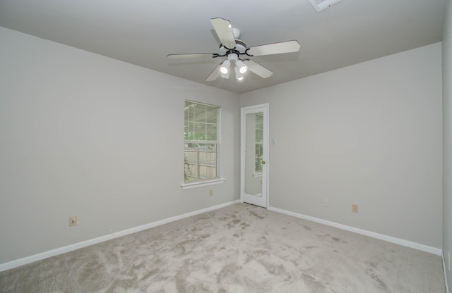 empty room featuring light carpet and ceiling fan