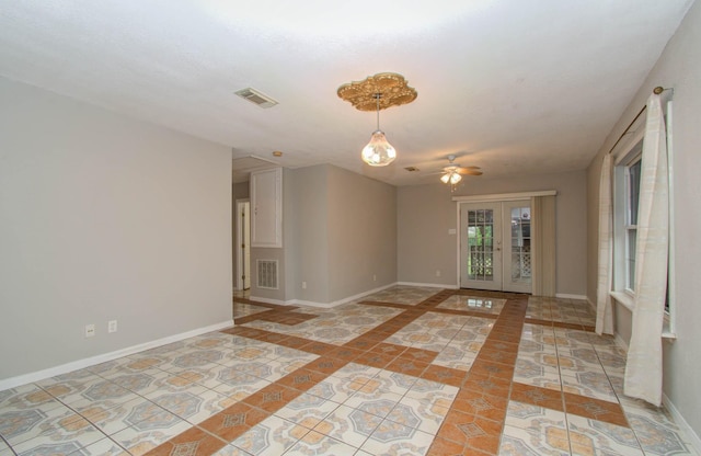 spare room with ceiling fan, french doors, and light tile patterned floors