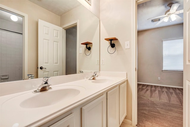 bathroom featuring ceiling fan and vanity