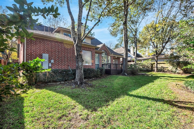 exterior space featuring a lawn and a deck