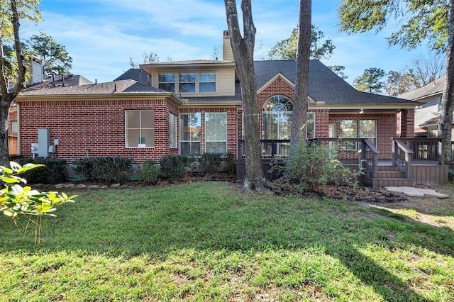 rear view of house with a yard