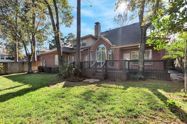 rear view of house with a yard and a deck