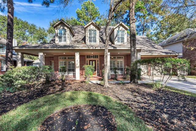 cape cod-style house featuring a porch